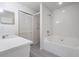 Bathroom featuring a tub/shower combo with white subway tile, white vanity, and gray tile floors at 2355 Bentley Dr, Palm Harbor, FL 34684