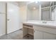 Bright bathroom with a single sink vanity, modern mirror, and shower with glass door at 2355 Bentley Dr, Palm Harbor, FL 34684