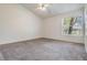 Spacious bedroom with a ceiling fan, neutral carpet, and a window that provides natural light at 2355 Bentley Dr, Palm Harbor, FL 34684