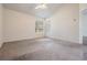 Large bedroom showing neutral carpet, a ceiling fan, and bright windows with natural light at 2355 Bentley Dr, Palm Harbor, FL 34684