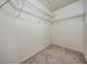 Walk-in closet with white walls and shelving; neutral carpeted floor at 2355 Bentley Dr, Palm Harbor, FL 34684