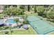 Aerial view of community amenities, including a pool, tennis courts, and landscaped areas at 2355 Bentley Dr, Palm Harbor, FL 34684