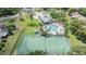 Aerial view of the community tennis courts and pool with recreational areas at 2355 Bentley Dr, Palm Harbor, FL 34684