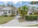 Beautiful single-story home featuring lush landscaping and a charming walkway at 2355 Bentley Dr, Palm Harbor, FL 34684