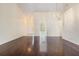 Living room showcasing wood floors and an open layout that connects to the entryway and adjacent rooms at 2355 Bentley Dr, Palm Harbor, FL 34684