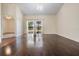 Open living room with wood floors and sliding glass doors offering views of the outdoors and connecting rooms at 2355 Bentley Dr, Palm Harbor, FL 34684