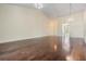 Open living room with wood floors and adjacent rooms providing an airy and spacious living area at 2355 Bentley Dr, Palm Harbor, FL 34684