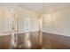 Living room showcasing wood floors and an open layout that connects to the entryway and adjacent rooms at 2355 Bentley Dr, Palm Harbor, FL 34684