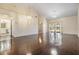 Open living room featuring vaulted ceilings, beautiful wood floors, and sliding glass doors to the outdoors at 2355 Bentley Dr, Palm Harbor, FL 34684