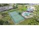 Community amenities include a tennis court and swimming pool with lounge chairs, surrounded by lush landscaping and mature trees at 2355 Bentley Dr, Palm Harbor, FL 34684