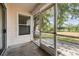 Screened-in patio with a view of the backyard and access to the outdoors at 2355 Bentley Dr, Palm Harbor, FL 34684
