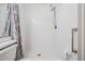 Clean white tiled shower stall complete with shower head, fixtures and decorative shower curtain at 2355 Bentley Dr, Palm Harbor, FL 34684