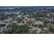 Aerial view shows a quiet neighborhood, showcasing the property's lot, fencing, and mature trees at 2415 Devonwoode Pl, Seffner, FL 33584