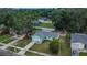 Aerial view of home showcasing its manicured lawn, mature trees, and well-maintained exterior at 2415 Devonwoode Pl, Seffner, FL 33584