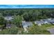 An aerial shot of a home surrounded by mature trees and well-maintained lawns at 2415 Devonwoode Pl, Seffner, FL 33584