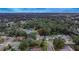 An aerial view of a quaint home nestled in a densely wooded neighborhood at 2415 Devonwoode Pl, Seffner, FL 33584
