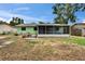 A back yard featuring a screened-in patio, wood deck and tidy lawn at 2415 Devonwoode Pl, Seffner, FL 33584