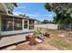 Back yard featuring a screened-in patio and mature trees at 2415 Devonwoode Pl, Seffner, FL 33584