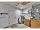 Unfinished basement with painted walls, utilities, and a door to the backyard at 2415 Devonwoode Pl, Seffner, FL 33584