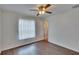 Bedroom with hardwood floors, ceiling fan, natural light and access to the en suite at 2415 Devonwoode Pl, Seffner, FL 33584