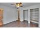 Bedroom featuring hardwood floors, a ceiling fan, open shelving, and an en suite bathroom at 2415 Devonwoode Pl, Seffner, FL 33584