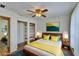 Bright bedroom featuring hardwood floors, a ceiling fan, open shelving, and closet at 2415 Devonwoode Pl, Seffner, FL 33584