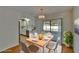 Open dining area featuring hardwood floors, chandelier, and bright natural light at 2415 Devonwoode Pl, Seffner, FL 33584