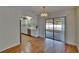 Open dining area featuring hardwood floors and bright natural light at 2415 Devonwoode Pl, Seffner, FL 33584