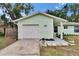 Home exterior showing a well-manicured lawn, an attached garage, and a walkway to the front door at 2415 Devonwoode Pl, Seffner, FL 33584
