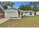Charming single-story home with a well-maintained lawn, inviting entrance, and attached garage at 2415 Devonwoode Pl, Seffner, FL 33584