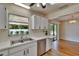 Open kitchen featuring a double sink, stainless steel dishwasher, and a view of the backyard at 2415 Devonwoode Pl, Seffner, FL 33584