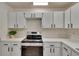 Bright kitchen featuring white cabinets, modern countertops, and stainless steel appliances at 2415 Devonwoode Pl, Seffner, FL 33584
