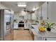 Well-lit kitchen with stainless steel appliances, white cabinets, and plenty of counter space at 2415 Devonwoode Pl, Seffner, FL 33584