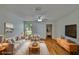 Bright living room with hardwood floors, ceiling fan, and neutral furniture arrangement at 2415 Devonwoode Pl, Seffner, FL 33584