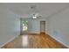 Bright living room featuring hardwood floors, a front-facing window, and closet for storage at 2415 Devonwoode Pl, Seffner, FL 33584