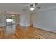Open-concept living area with hardwood floors, sliding glass doors, and ceiling fan at 2415 Devonwoode Pl, Seffner, FL 33584