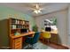 Home office staged with dual computer desks, chair, shelving, and decor at 2415 Devonwoode Pl, Seffner, FL 33584
