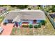 Aerial view of a single-Gathering home with a unique architectural style and a well-maintained landscape at 2432 Caretta Ave, Spring Hill, FL 34609
