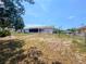 Backyard featuring a screen porch, walkway, and large yard at 2432 Caretta Ave, Spring Hill, FL 34609