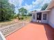 Backyard view from patio, with shed, green trees and lawn at 2432 Caretta Ave, Spring Hill, FL 34609