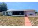 Backyard featuring a screen porch, walkway, and large yard at 2432 Caretta Ave, Spring Hill, FL 34609