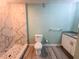 Bathroom showcasing a tiled walk-in shower, modern vanity, and updated toilet at 2432 Caretta Ave, Spring Hill, FL 34609