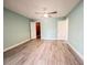 This spacious bedroom has modern flooring, a ceiling fan, and white doors to the hall and closet at 2432 Caretta Ave, Spring Hill, FL 34609