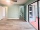 Spacious bedroom featuring modern flooring and slider doors leading to enclosed lanai at 2432 Caretta Ave, Spring Hill, FL 34609
