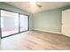 Bedroom features neutral walls, modern flooring, and sliding glass doors to the lanai at 2432 Caretta Ave, Spring Hill, FL 34609
