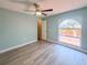 Bedroom featuring a ceiling fan, modern flooring, and a white arched window at 2432 Caretta Ave, Spring Hill, FL 34609