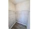 This is a walk-in closet with shelving, and wood grain walls and floors at 2432 Caretta Ave, Spring Hill, FL 34609