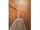 Inside a walk in closet with shelving, and wood grain walls and modern floors at 2432 Caretta Ave, Spring Hill, FL 34609