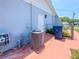 Home exterior with AC unit, back door, and walkway at 2432 Caretta Ave, Spring Hill, FL 34609