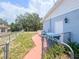 Side yard of home with walkway, trash cans, and fencing at 2432 Caretta Ave, Spring Hill, FL 34609